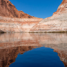 Load image into Gallery viewer, A photograph of Lakes Powell rocks formation, reflecting on the water. Ana Sosa's photography
