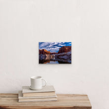 Load image into Gallery viewer, "Snow Wonderland 8" x 12" - A cozy corner with books and a mug, highlighting the charm of this smaller piece."