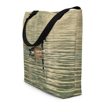 Load image into Gallery viewer, Tote bag with all-over print of a duck swimming in the reflection of the green water, showing side cut