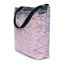 Load image into Gallery viewer, A tote bag printed with pink tones of sunset reflections, seen from the side. Versatile beach bag with black stripes.