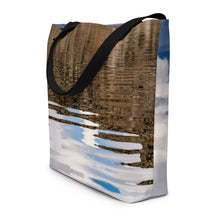 Load image into Gallery viewer, Full tote bag printed with an image of reflections on the water, displayed sideways to show details, with vivid brown, white and sky blue tones.
