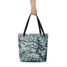 Load image into Gallery viewer, A beautiful tote bag with a brilliant reflection in the turquoise water. Black handle and front view and carried in hand to show size.
