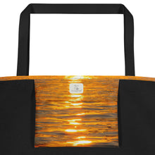 Load image into Gallery viewer, A tote bag, seen from the inside and containing an inner bag printed with an orange reflection and Ana's CameraWork branding