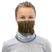 Load image into Gallery viewer, A model wearing a neck gaiter. All over print terracotas colors, front side.