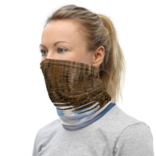 Load image into Gallery viewer, A model wearing a neck gaiter. All over print terracotas colors, left side.