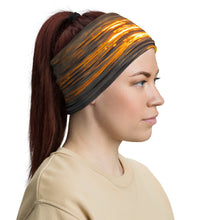 Load image into Gallery viewer, A woman wearing a neck gaiter. All over print orange, right  side.