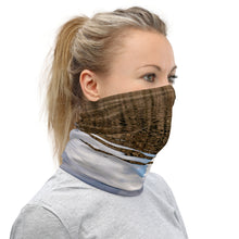 Load image into Gallery viewer, A model wearing a neck gaiter. All over print terracotas colors, right side.