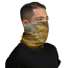 Load image into Gallery viewer, A man wearing a gaiter with an all-over terracotta-colored print, seen from the right side.