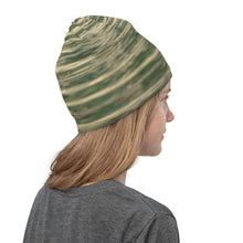 Load image into Gallery viewer, Reflections on water in green colors printed on a gaiter, showing the right side used as a mask.