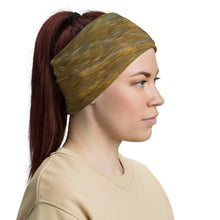 Load image into Gallery viewer, A woman with a gaiter on her head; with colorful print in terracotta, blue and yellow.
