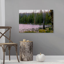 Load image into Gallery viewer, A 24x36" image with a pink sunset reflected over Crystal Lake - Utah, downloadable with a user license. A pine forest in the background of the photo, which is displayed in a waiting room