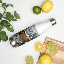 Load image into Gallery viewer, Stainless steel water bottle white 17 oz. On shelf comparing size with 2 limes, cutting board, and mint bouquet. Front side, a cold winter Cutler Reservoir, UT., image and 'Sip it Whether It's hot or cold' printed.