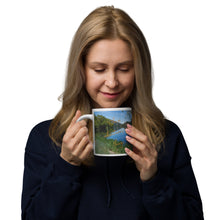 Load image into Gallery viewer, A woman with a white glossy 20 oz mug with Mantua Reservoir image. Handle on left