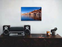 Load image into Gallery viewer, "’Layers of Time’ 16" x 24" - Size comparison with small radio on a wood table, highlighting the print's impact in various settings."
