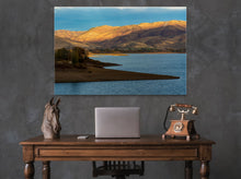 Load image into Gallery viewer, 'Sunset Over The Mountains' - 40"x60" on a dark grey wall in an elegant room with a small Victorian-style desk, an antique phone, and a white laptop.