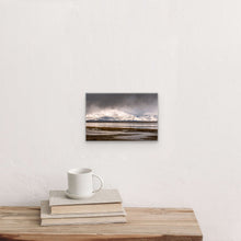 Load image into Gallery viewer, &quot;Winter&#39;s Embrace 8&quot; x 12&quot; - Intimate beauty on a white wall, the piece&#39;s size compared to books and a mug, creating a cozy corner.&quot;
