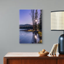 Load image into Gallery viewer, A limited edition 24&quot;x16&quot; portrait, titled &#39;A Ray of Light Through the Pine Tree&#39;, a beautiful image with twilight colors displayed on a gray wall next to a tan counter and lamp to compared size
