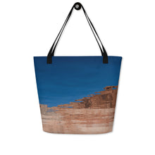 Load image into Gallery viewer, A tote bag, seen from another side, completely printed, blue sky and rock formations reflected on the water.

