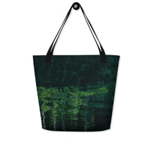 Load image into Gallery viewer, Full tote bag printed with a reflection of pando forest on the water, hanging on the wall. Back face
