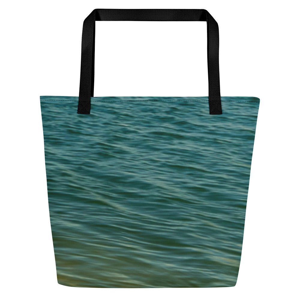A modern tote bag, where you can store everything that matters when you get to those warm beaches. Front printed with turquoise water waves.