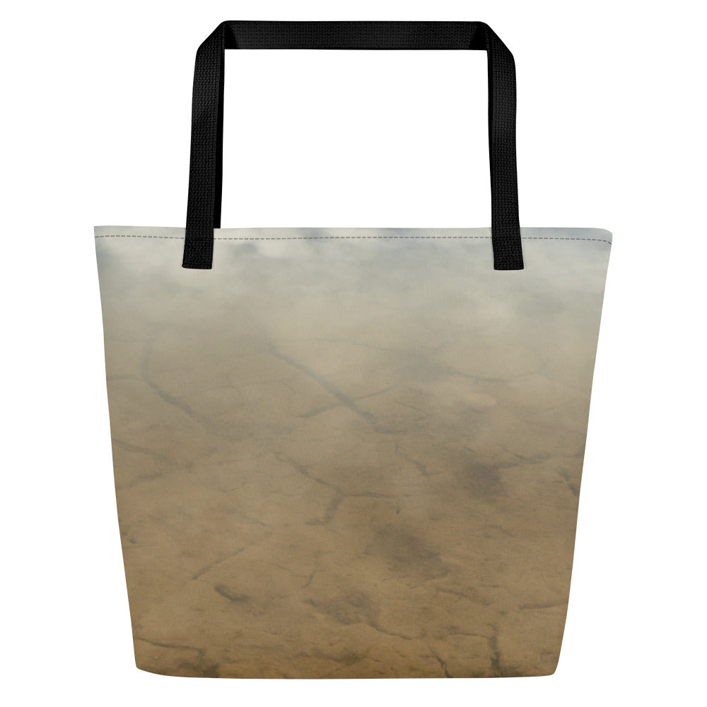 A modern tote bag, printed in terracotta colors, seen from one side, with black handles.