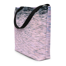 Load image into Gallery viewer, A tote bag printed with pink tones of sunset reflections, seen from the side. Versatile beach bag with black stripes.
