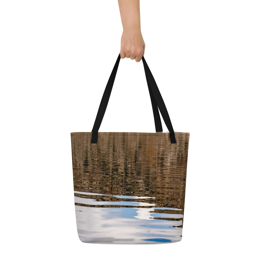 Full tote bag printed with an image of reflections on the water, displayed on its front side, with vivid brown, white and sky blue tones