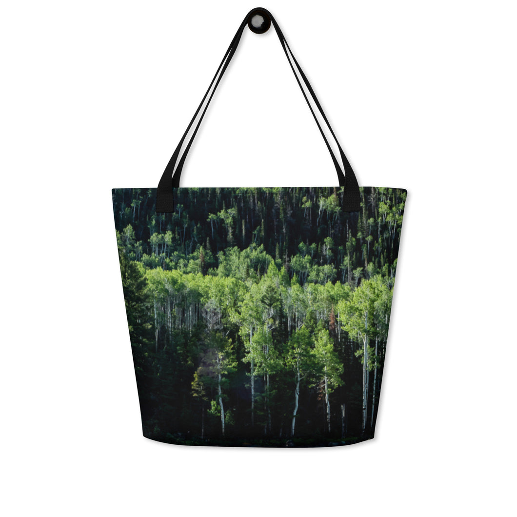 Tote bag full print with a pando forest landscape, hanging on the wall