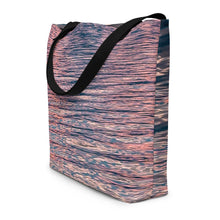 Load image into Gallery viewer, Tote bag with ethereal pink tones of sunset reflections, showing the side cut, versatile accessory that can be used to go to the beach
