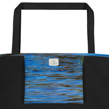 Load image into Gallery viewer, Large tote bag with all-over print and pocket, printed on the front with an image of blue reflections in the water. Closeup of the inside of the pocket
