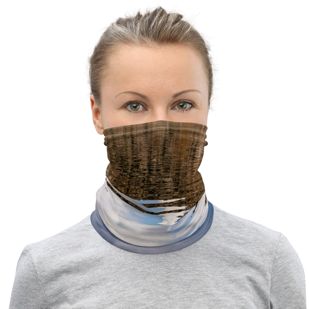A model wearing a neck gaiter. All over print terracotas colors, front side.