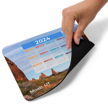 Load image into Gallery viewer, Mouse pad, functional with yearly calendar for 2024. Stay organized while enjoying a view of Moab.
