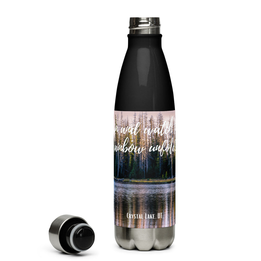 Stainless steel water bottle black 17 oz. Open to show details, front side, a colorful Crystal Lake image and 'Grin and watch the raimbow unfould' printed.
