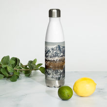 Load image into Gallery viewer, Stainless steel water bottle white 17 oz. On shelf comparing size with 2 lime and mint bouquet. Front side, a cold winter Cutler Reservoir, UT., image and &#39;Sip it Whether It&#39;s hot or cold&#39; printed.
