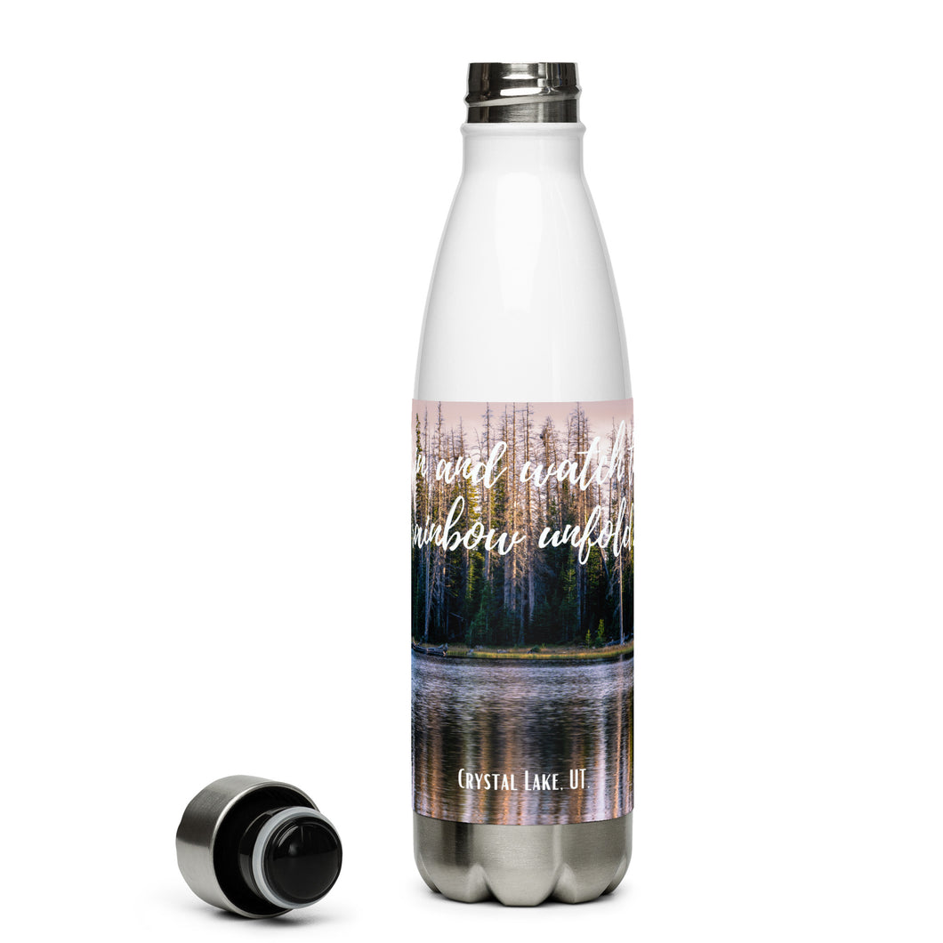 Stainless steel water bottle white 17 oz. Open to show details, front side, a colorful Crystal Lake image and 'Grin and watch the raimbow unfould' printed.