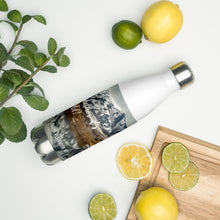 Load image into Gallery viewer, Stainless steel water bottle white 17 oz. On shelf comparing size with 2 limes, cutting board, and mint bouquet. Front side, a cold winter Cutler Reservoir, UT., image and &#39;Sip it Whether It&#39;s hot or cold&#39; printed.
