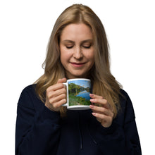 Load image into Gallery viewer, A woman with a white glossy 11 oz mug with Mantua Reservoir image. Handle on left
