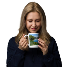 Load image into Gallery viewer, A woman with a white glossy 15 oz mug with Mantua Reservoir image. Handle on left
