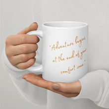 Load image into Gallery viewer, White 20-oz glossy mug with text: &quot;Adventure begins at the end of your confort zone&quot;, handle on right.
