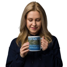 Load image into Gallery viewer, A woman with a white glossy 20 oz mug with Mantua Reservoir image. Handle on right
