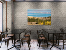 Load image into Gallery viewer, &quot;&#39;Enchanting Hues&#39; 40&quot; x 60&quot; - Adorning a dark cream brick wall in a rustic restaurant with glass tables and dark metal chairs, adding life and vibrancy to the space.&quot;
