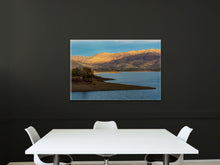 Load image into Gallery viewer, &#39;Sunset Over The Mountains&#39; - 24&quot;x36&quot; hanging on a black wall in a corporate meeting room with white furniture, creating a contrasting and elegant atmosphere.

